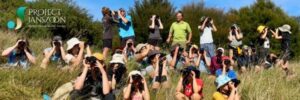 people on a grassy hill