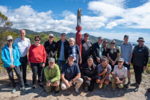 people on a hill by the sea