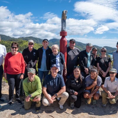 people on a hill by the sea