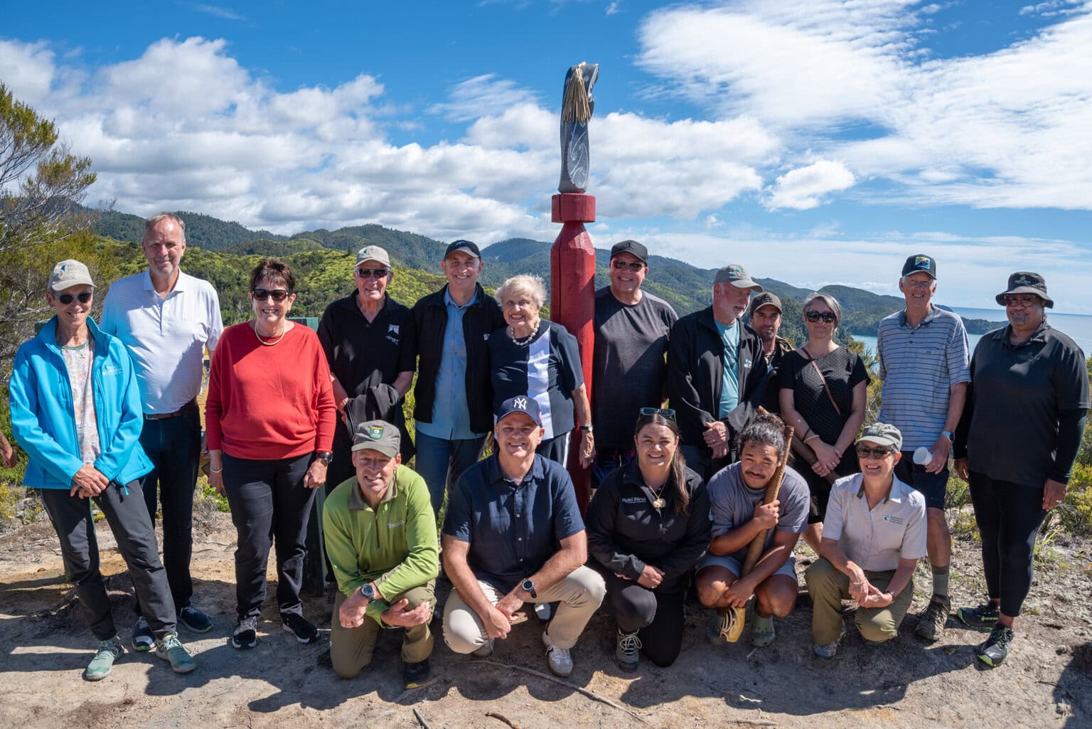 people on a hill by the sea